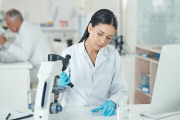 A good lab technician is meticulous and cautious. a young scientist working with samples in a lab.
