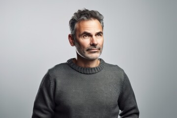 Portrait of a handsome middle-aged man in a gray sweater
