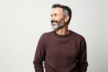 Obraz premium Portrait of a middle-aged man in a brown sweater on a white background