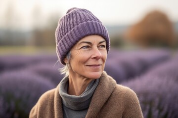 Portrait of mature woman standing in lavender field, looking away