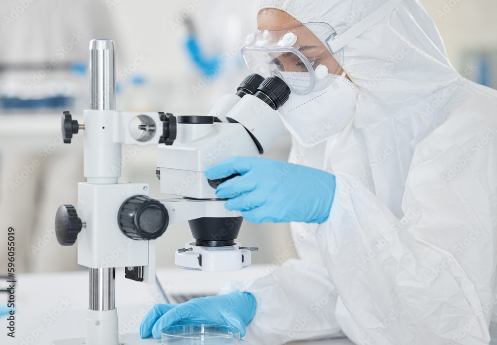 Poster Supporting scientific investigations with detailed analysis. a scientist wearing a radiation suit while using a microscope in a lab.