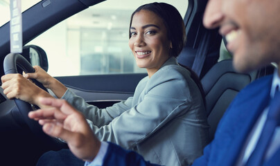 Its gonna be hard to say no.... Cropped portrait of an attractive young woman sitting in a new car...