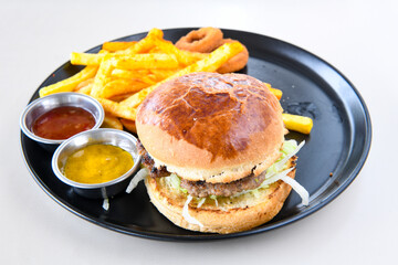 Big tasty burger with beef cutlet on a plate