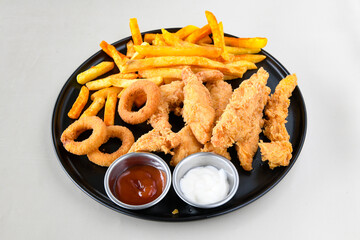 Fried Chicken breast hot crispy strips crunchy chicken tenders  isolated on white background.Nuggets isolated on white background on a plate