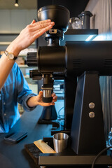 Professional barista using modern equipment in a coffeehouse