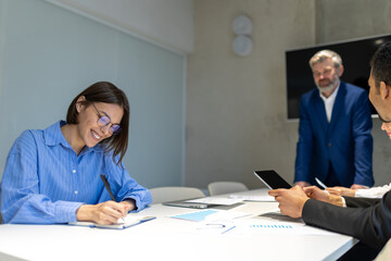 Business partners having negotiations and signing the contract