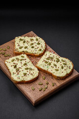 Grilled toast with avocado paste, eggs, cream cheese, salt, spices and herbs