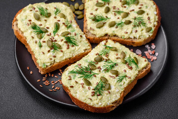 Grilled toast with avocado paste, eggs, cream cheese, salt, spices and herbs