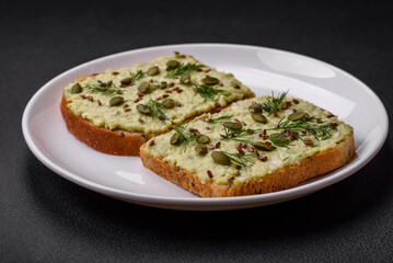 Grilled toast with avocado paste, eggs, cream cheese, salt, spices and herbs