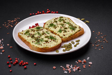 Grilled toast with avocado paste, eggs, cream cheese, salt, spices and herbs