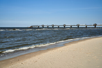 Concrete pier on a sandy beach by the Baltic Sea in Miedzyzdroje