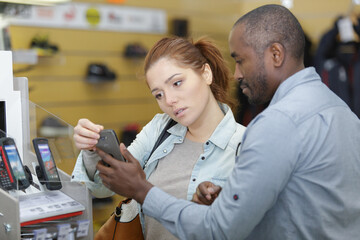 woman getting assistance in a cellular phone shop