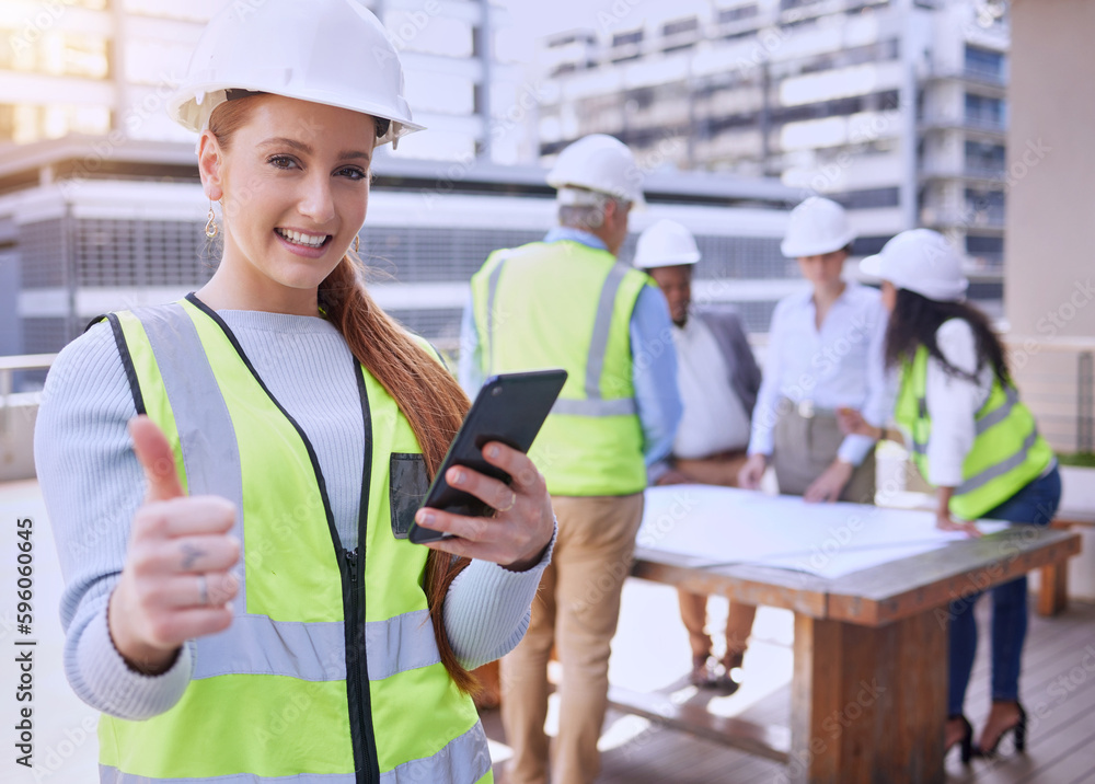 Poster were good to go. cropped portrait of an attractive young female construction worker using a cellphon