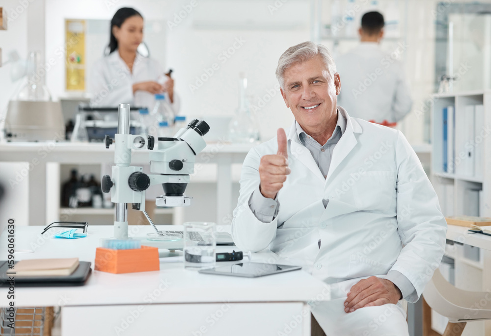Poster Its all good here. Portrait of a senior scientist showing thumbs up while working in a lab.