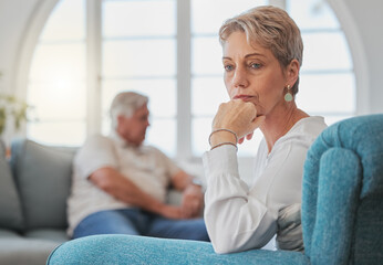 Has it all been worth it. a senior couple looking sad and upset while sitting in their living room...