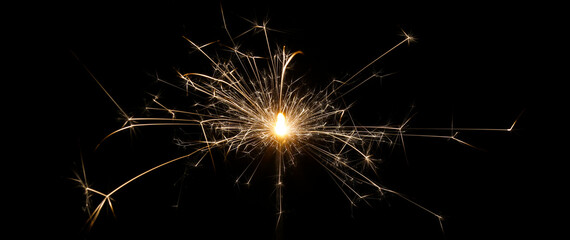 A burning sparkler with black background