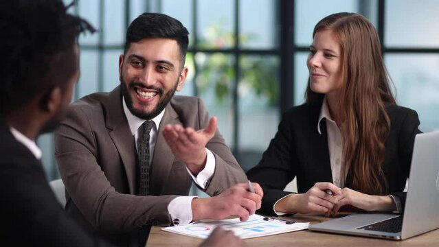 sitting at the table. Young business people working in the office