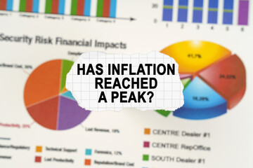 On diagrams and graphs lies torn paper with the inscription - Has inflation reached a peak