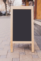 Fototapeta na wymiar Mockup empty blank of cafe menu chalkboard on street - copy space and empty space for advertising mock-up