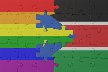 puzzle with the flag of rainbow gay pride and south sudan . macro.concept.