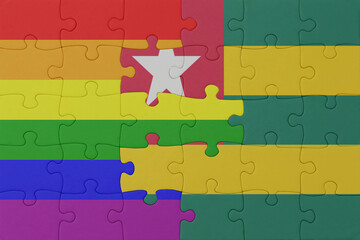 puzzle with the flag of rainbow gay pride and togo . macro.concept.