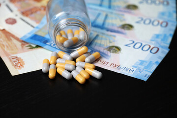 Pills on banknotes of the russian rubles. Medication in capsules, concept of pharmaceutical business, rise in price of medicines, healthcare in Russia