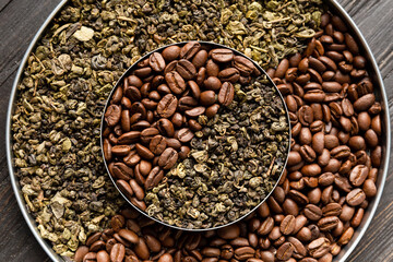 Green tea and coffee grains on a dark wooden background top view.