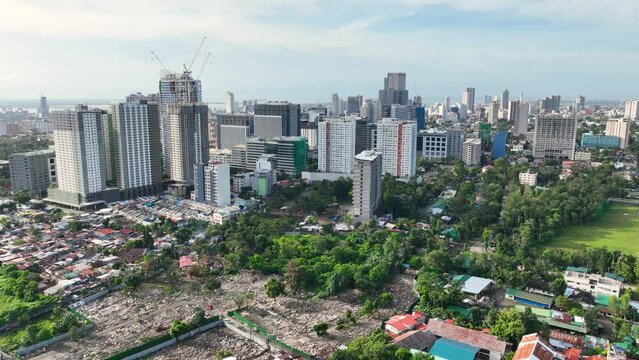Aerial shot of the poor neighborhoods mixed in with new modern high-rises in Cebu City Philippines.
