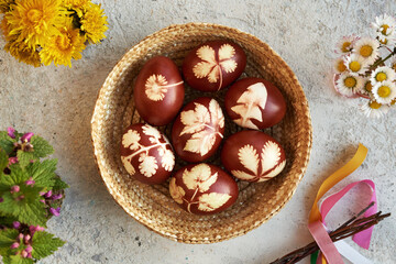 Brown Easter eggs with a pattern of leaves in a basket