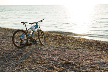 Fototapeta premium bike on the beach at dawn on the black sea