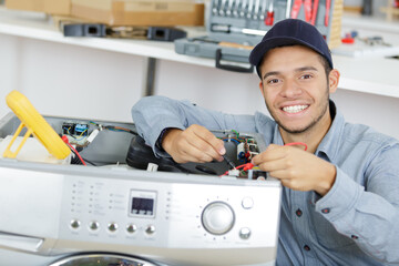 worker repairing the washing machine in the bathroom