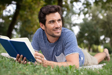 a nice looking man is reading a book