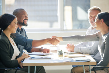 Youve got yourself a deal. two businesspeople shaking hands during a meeting in the boardroom.