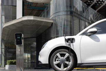 Progressive electric vehicle recharging battery at charging station powered by sustainable clean...