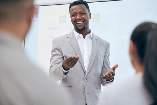 Lets get down to business. a young businessman doing a prsentation in a meeting at work.