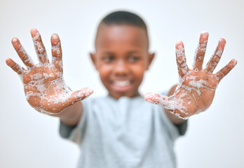 Keep your hands happy and healthy. a little boy showing his hands after washing them at home.