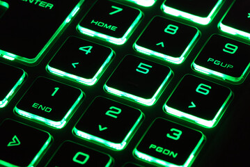 laptop keyboard numeric pad with green lighting close-up