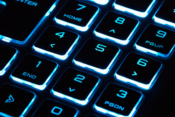 laptop keyboard numeric pad with blue lighting close-up