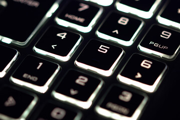 laptop keyboard numeric pad with orange lighting close-up