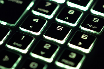 laptop keyboard numeric pad with yellow lighting close-up