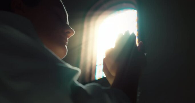 Devout woman knelt down in prayer to God in church. Religious faith and spirituality. Christianity and belief.