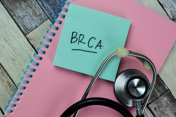 Concept of BRCA write on sticky notes isolated on Wooden Table.
