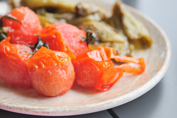 baked tomato and capsicum on plate 