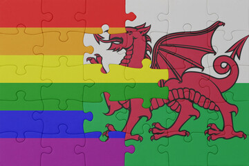 puzzle with the flag of rainbow gay pride and wales . macro.concept.