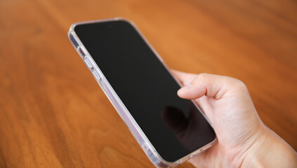 An empty black phone screen mock-up symbolizes the potential for disconnection and addiction to technology, highlighting the need for balance and mindfulness in our relationship with digital devices