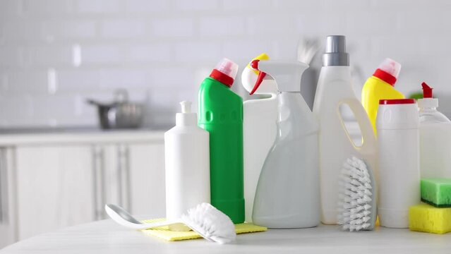 A set of different cleaning and disinfection products against the background of the home interior 
