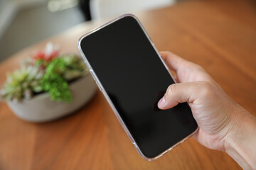 An empty black phone screen mock-up symbolizes the potential for disconnection and addiction to technology, highlighting the need for balance and mindfulness in our relationship with digital devices