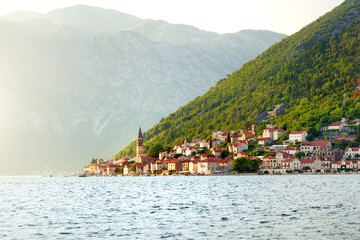 Fototapeta na wymiar Breathtaking panoramic view of the ancient city of Perast, Montenegro. Old medieval little town with red roofs. Amazing Kotor bay on the coast of Adriatic sea.