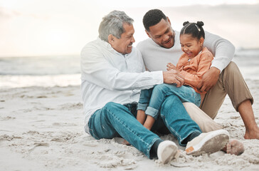She loves the beach. Full length shot of an adorable little girl on the beach with her father and grandfather.
