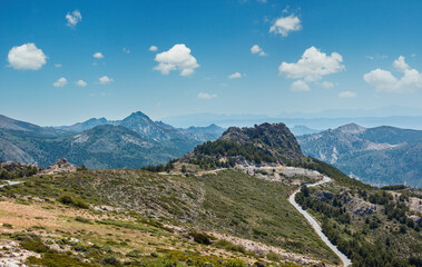 Summer mountain landscape with alpine road (Sierra Nevada National Park, near Granada, Spain).